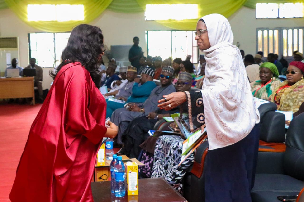Two participants in conversation during a university gathering