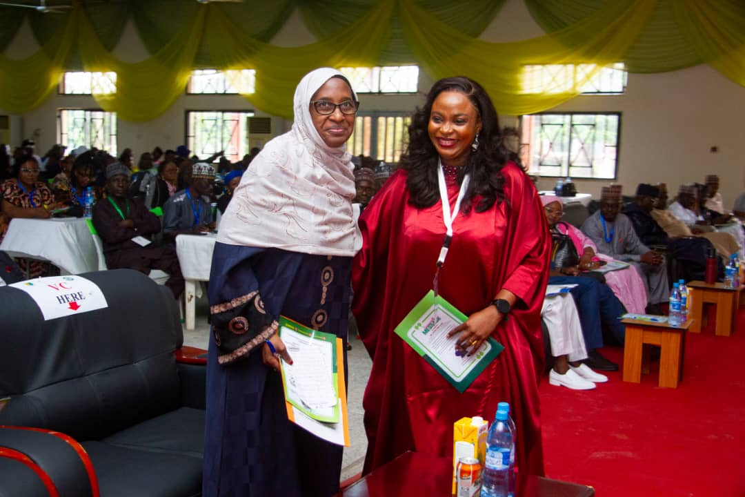 Two participants standing together during a university programme